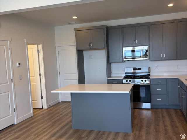 6901 W S Jordan Pkwy, South Jordan, UT 84009 - kitchen featuring appliances with stainless steel finishes, dark wood finished floors, light countertops, recessed lighting, and a center island