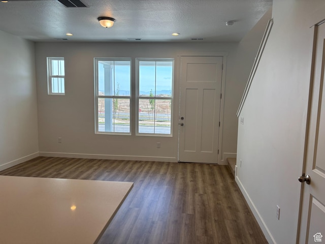 6901 W S Jordan Pkwy, South Jordan, UT 84009 - foyer entrance featuring dark wood finished floors, baseboards, and a textured ceiling