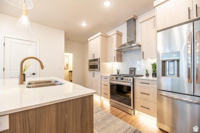 4337 W 5430 S Unit D, Roy, UT 84067 - kitchen with stainless steel appliances, wall chimney exhaust hood, a sink, light wood-style floors, and light countertops
