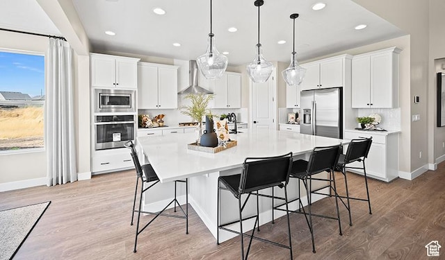 1044 S 3170 E Unit 219, Spanish Fork, UT 84660 - kitchen featuring stainless steel appliances, wall chimney range hood, recessed lighting, a spacious island, and white cabinets