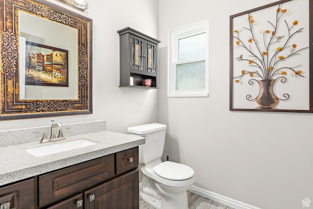 137 Stern Ct, Stansbury Park, UT 84074 - bathroom with toilet, vanity, and baseboards