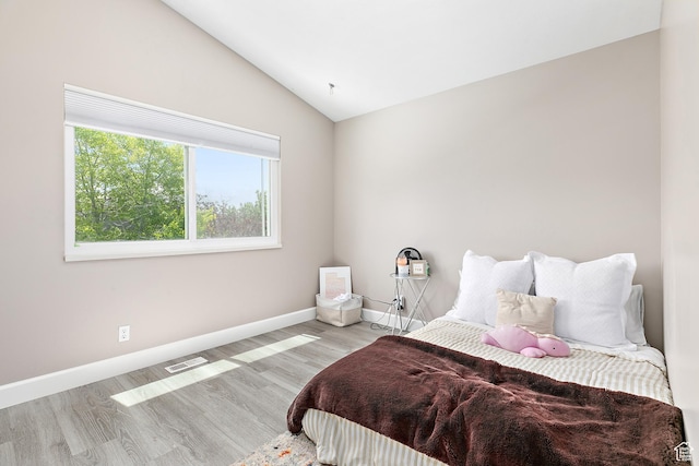 137 Stern Ct, Stansbury Park, UT 84074 - bedroom with lofted ceiling, baseboards, and wood finished floors