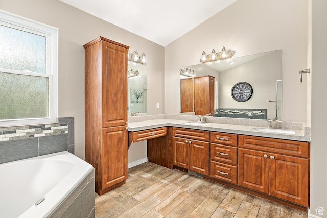 137 Stern Ct, Stansbury Park, UT 84074 - full bath featuring healthy amount of natural light, double vanity, a bath, wood finished floors, and lofted ceiling