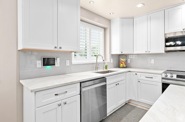 137 Stern Ct, Stansbury Park, UT 84074 - kitchen featuring stainless steel appliances, a sink, white cabinets, tasteful backsplash, and recessed lighting