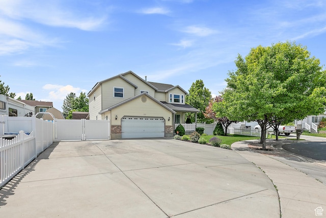 137 Stern Ct, Stansbury Park, UT 84074 - view of front of house with driveway, brick siding, an attached garage, and a gate