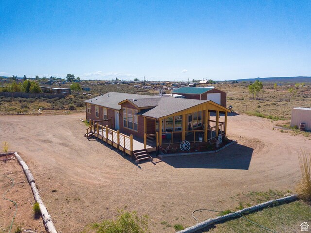 16 E Pearly Ln, La Sal, UT 84530 - back of house with driveway, a wooden deck, and a shingled roof