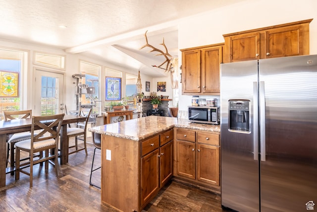 16 E Pearly Ln, La Sal, UT 84530 - kitchen featuring stainless steel appliances, brown cabinets, a peninsula, and dark wood finished floors