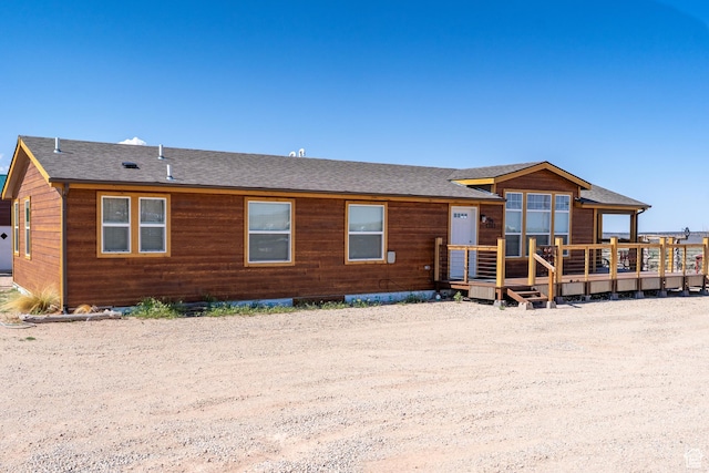 16 E Pearly Ln, La Sal, UT 84530 - rear view of house featuring a wooden deck and a shingled roof
