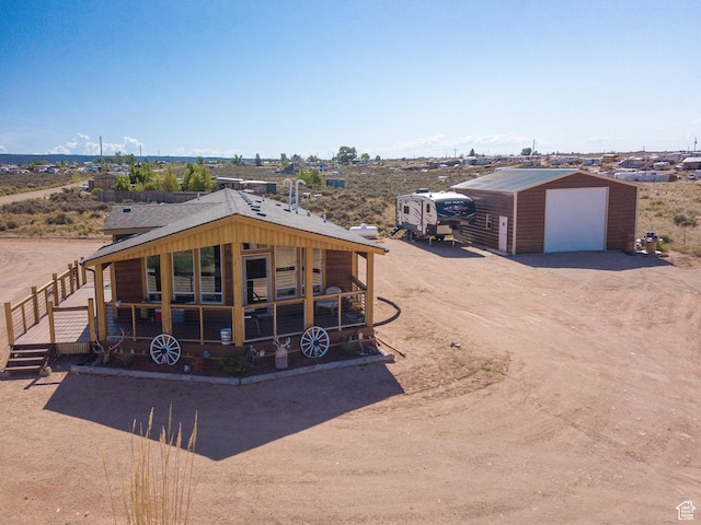 16 E Pearly Ln, La Sal, UT 84530 - back of property with a garage, an outbuilding, and dirt driveway