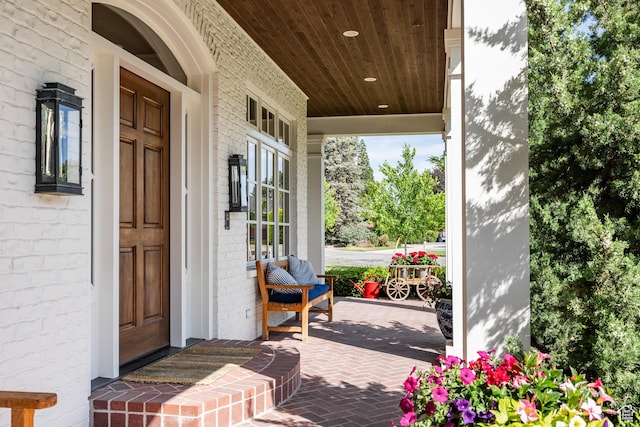 2590 E Olympus Dr, Holladay, UT 84124 - doorway to property with covered porch and brick siding