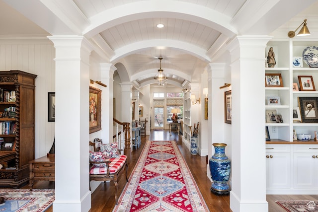 2590 E Olympus Dr, Holladay, UT 84124 - hall with ornate columns, dark wood-style floors, arched walkways, lofted ceiling, and built in shelves