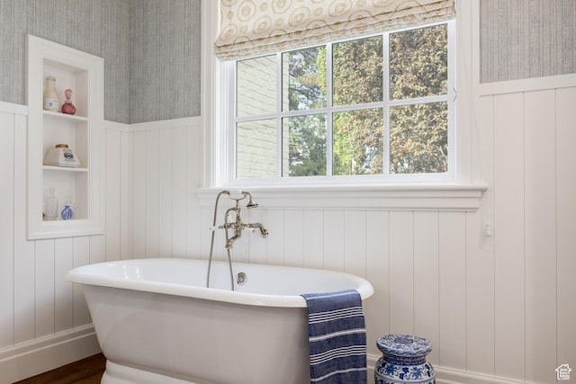 2590 E Olympus Dr, Holladay, UT 84124 - bathroom featuring a freestanding bath, wainscoting, a decorative wall, wallpapered walls, and wood finished floors