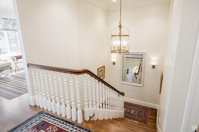 2590 E Olympus Dr, Holladay, UT 84124 - stairway featuring wood finished floors, a chandelier, and baseboards