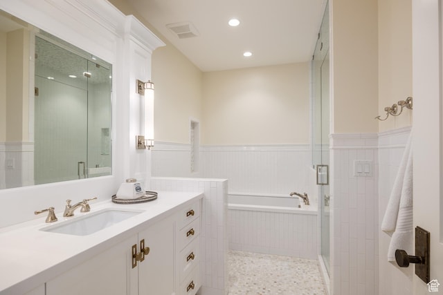 2590 E Olympus Dr, Holladay, UT 84124 - full bathroom featuring vanity, a garden tub, wainscoting, a stall shower, and recessed lighting