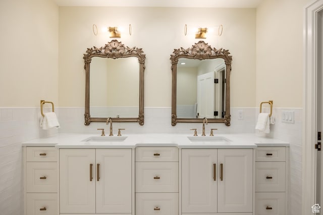 2590 E Olympus Dr, Holladay, UT 84124 - full bath featuring double vanity, tile walls, and a wainscoted wall