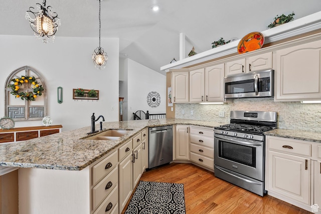 896 E 380 N, Heber City, UT 84032 - kitchen featuring stainless steel appliances, a sink, a peninsula, decorative backsplash, and vaulted ceiling