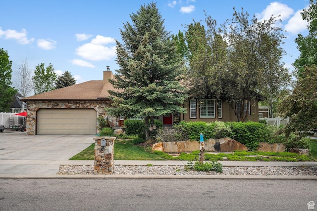 896 E 380 N, Heber City, UT 84032 - obstructed view of property with an attached garage, concrete driveway, a chimney, and stone siding