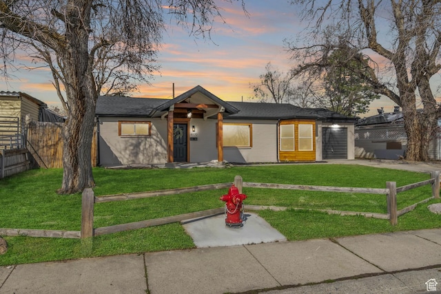 4970 S 4720 W, Kearns, UT 84118 - mid-century inspired home featuring an attached garage, driveway, a shingled roof, and brick siding
