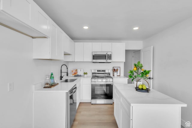 4970 S 4720 W, Kearns, UT 84118 - kitchen with appliances with stainless steel finishes, a sink, recessed lighting, white cabinetry, and a center island