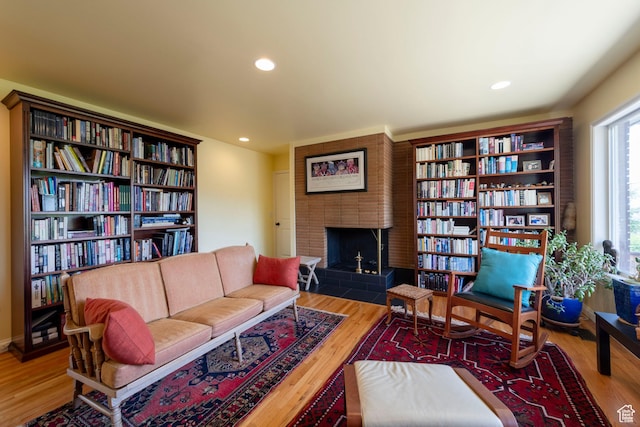 3555 E Hermes Dr S, Salt Lake City, UT 84124 - sitting room with a brick fireplace, wood finished floors, and recessed lighting