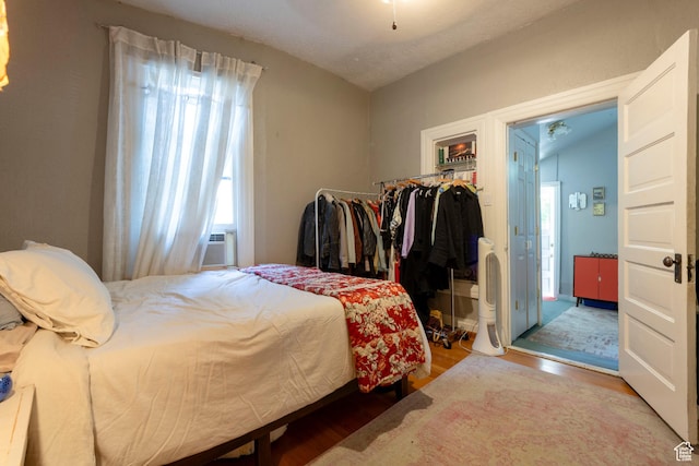 233 S 1100 E, Salt Lake City, UT 84102 - bedroom featuring wood finished floors, lofted ceiling, and cooling unit