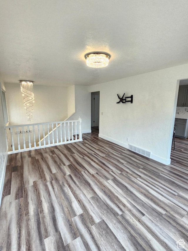 317 S 200 W, Price, UT 84501 - unfurnished room with wood finished floors, baseboards, and a chandelier