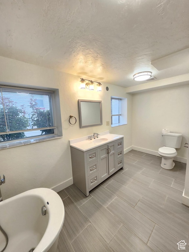 317 S 200 W, Price, UT 84501 - full bathroom featuring vanity, a textured ceiling, a bathtub, baseboards, and toilet