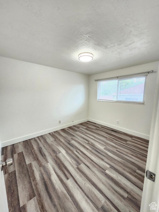 317 S 200 W, Price, UT 84501 - unfurnished room with wood finished floors, baseboards, and a textured ceiling