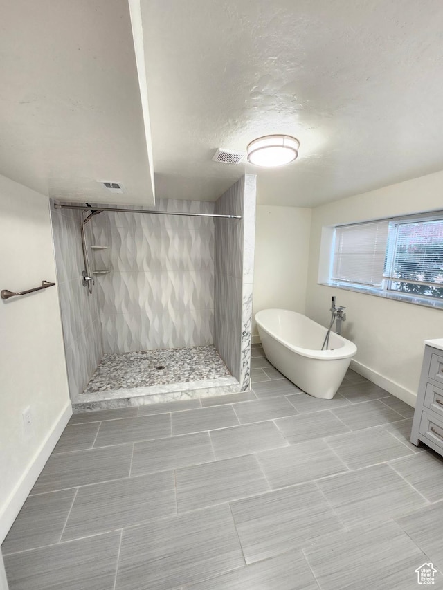 317 S 200 W, Price, UT 84501 - bathroom with a stall shower, a soaking tub, baseboards, and vanity