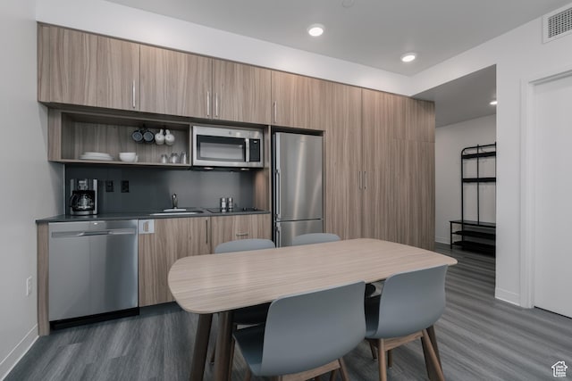 2670 Canyons Resort Dr Unit 113, Park City, UT 84098 - kitchen featuring appliances with stainless steel finishes, dark wood-style floors, baseboards, a sink, and modern cabinets