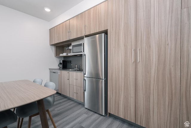 2670 Canyons Resort Dr Unit 113, Park City, UT 84098 - kitchen featuring stainless steel appliances, wood finished floors, a sink, modern cabinets, and open shelves