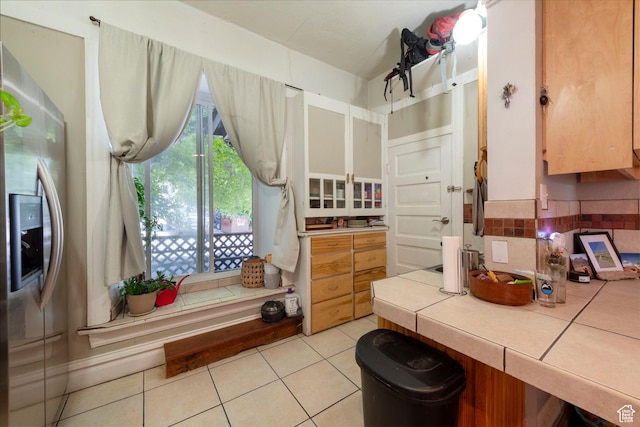 237 S 1100 E, Salt Lake City, UT 84102 - kitchen with tile countertops, stainless steel fridge, light tile patterned flooring, and decorative backsplash