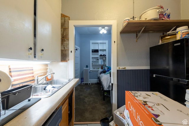 237 S 1100 E, Salt Lake City, UT 84102 - kitchen featuring freestanding refrigerator, radiator heating unit, dark carpet, a sink, and light countertops
