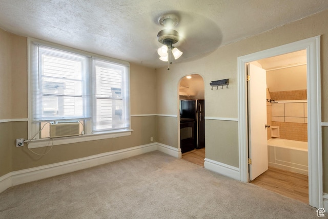 237 S 1100 E, Salt Lake City, UT 84102 - carpeted empty room with ceiling fan, arched walkways, baseboards, a textured ceiling, and cooling unit