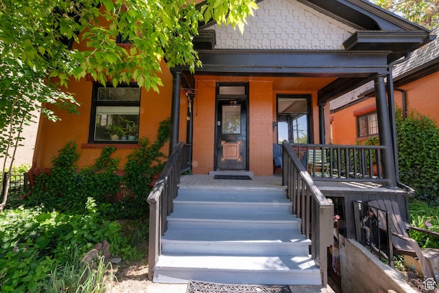 237 S 1100 E, Salt Lake City, UT 84102 - doorway to property featuring a porch and brick siding