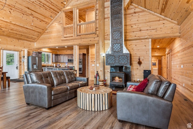 4708 Red Fir Way, Oakley, UT 84055 - living room with high vaulted ceiling, wood ceiling, wooden walls, a wood stove, and wood finished floors