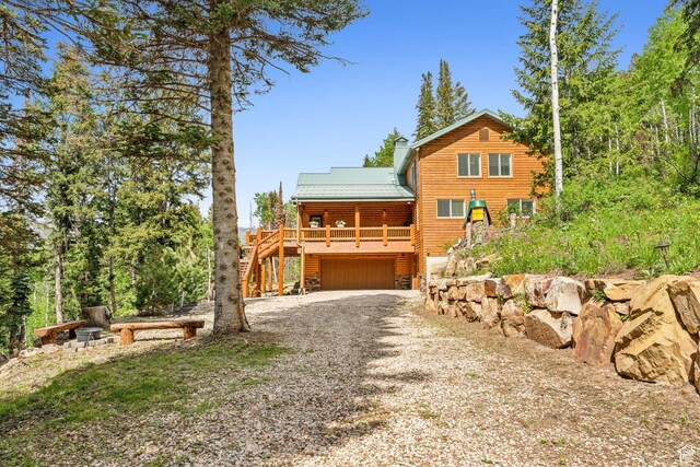 4708 Red Fir Way, Oakley, UT 84055 - view of front of home with gravel driveway, a garage, stairway, and metal roof