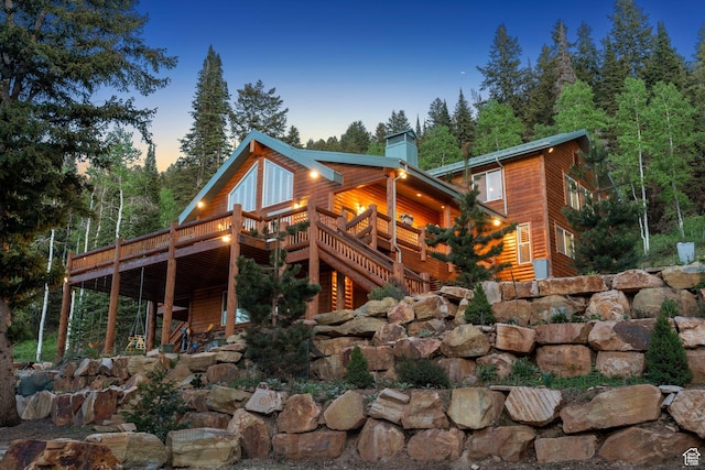 4708 Red Fir Way, Oakley, UT 84055 - rear view of property with a wooden deck, a chimney, and log veneer siding