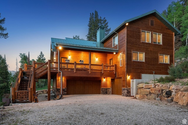 4708 Red Fir Way, Oakley, UT 84055 - rustic home with stairway, a chimney, gravel driveway, an attached garage, and metal roof
