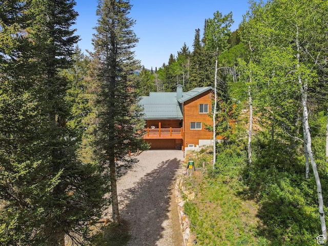 4708 Red Fir Way, Oakley, UT 84055 - rustic home with dirt driveway, a wooded view, metal roof, a chimney, and a wooden deck