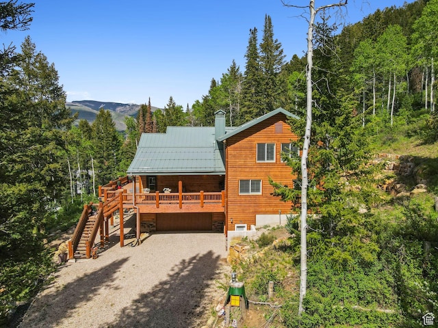 4708 Red Fir Way, Oakley, UT 84055 - view of front of house featuring stairway, an attached garage, gravel driveway, metal roof, and a standing seam roof