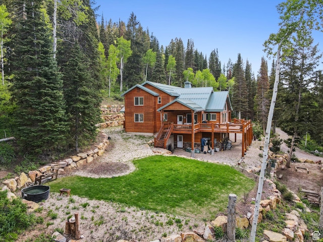 4708 Red Fir Way, Oakley, UT 84055 - rear view of house with stairs, a deck, a view of trees, a chimney, and a yard