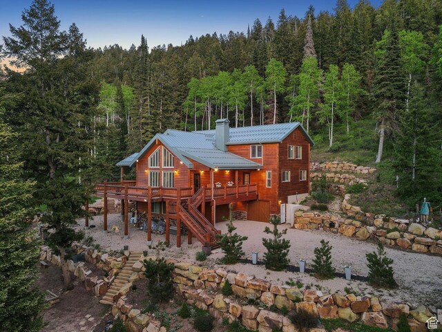4708 Red Fir Way, Oakley, UT 84055 - rear view of house with a wooded view, stairs, a chimney, driveway, and a deck