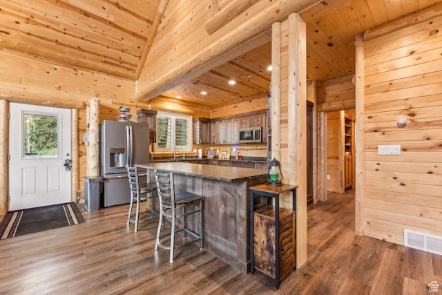 4708 Red Fir Way, Oakley, UT 84055 - kitchen with appliances with stainless steel finishes, dark countertops, a sink, a breakfast bar, and wood finished floors