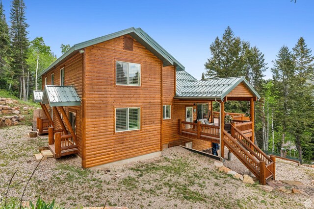 4708 Red Fir Way, Oakley, UT 84055 - rear view of house with stairway, metal roof, faux log siding, and a wooden deck