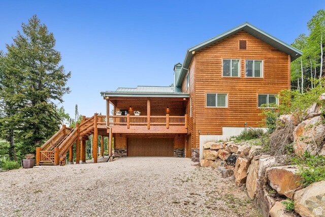 4708 Red Fir Way, Oakley, UT 84055 - back of property with an attached garage, metal roof, gravel driveway, and stairs