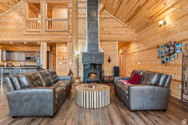 4708 Red Fir Way, Oakley, UT 84055 - living area with high vaulted ceiling, wooden ceiling, wood walls, a wood stove, and wood finished floors