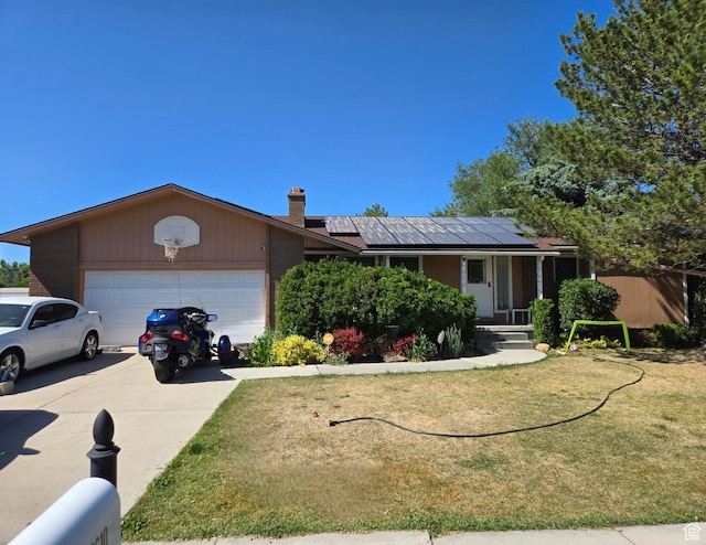 2610 W Bueno Vista Dr S, West Jordan, UT 84088 - single story home with a garage, roof mounted solar panels, a front yard, concrete driveway, and a chimney