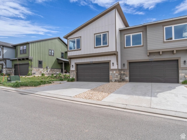 12852 N Belaview Way, Hideout, UT 84036 - view of front of house with stone siding, an attached garage, board and batten siding, and driveway