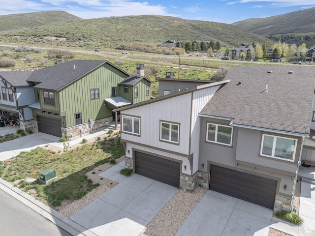 12852 N Belaview Way, Hideout, UT 84036 - view of front of home featuring stone siding, an attached garage, board and batten siding, concrete driveway, and a mountain view